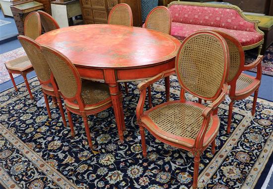 A chinoiserie style red-japanned dining suite, comprising an oval table and a set of eight chairs (two with arms) W.180cm